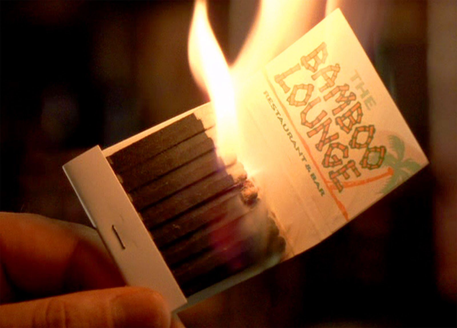A book of matches, lit, ready to burn down the Bamboo Lounge from the film, Goodfellas